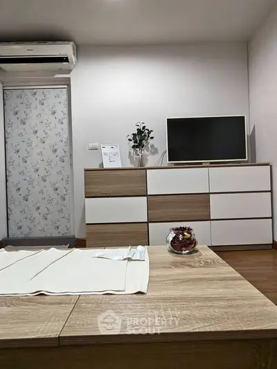 Modern living room with stylish furniture and air conditioning unit, perfect for comfortable living.