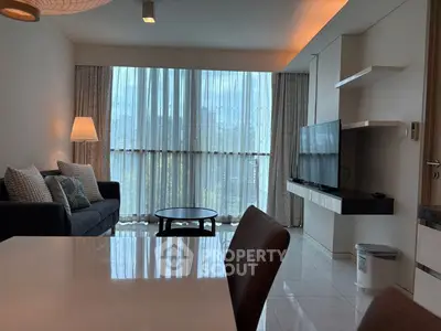 Modern living room with large windows and sleek furniture