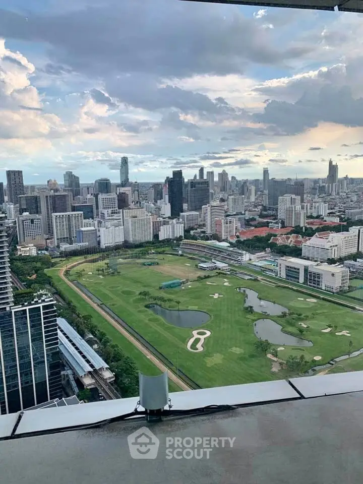 Stunning cityscape view from high-rise building overlooking golf course and skyline.