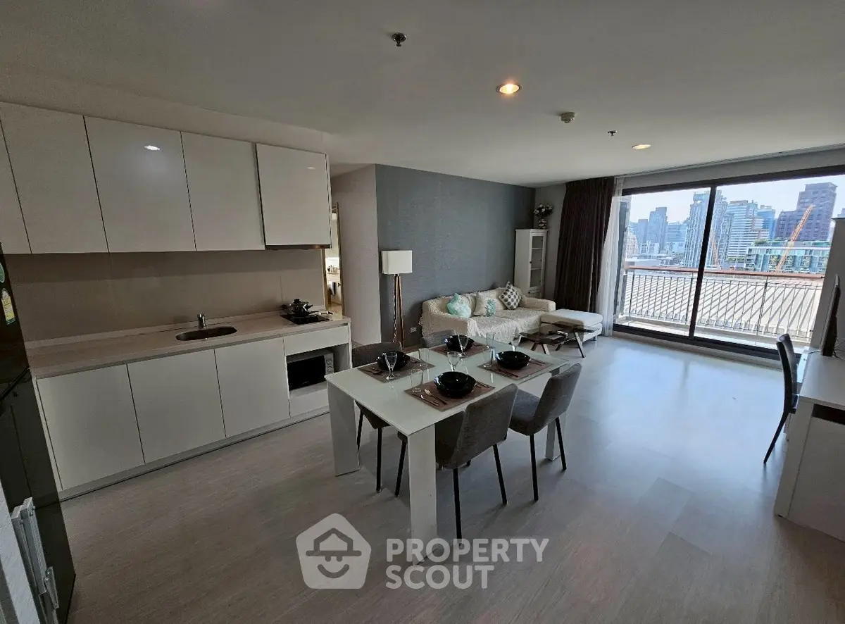 Modern open-plan living room with city view and sleek kitchen design