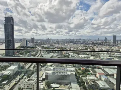 Stunning cityscape view from a high-rise balcony showcasing urban skyline and expansive horizon.