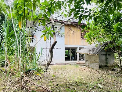 Charming rustic house surrounded by lush greenery, perfect for nature lovers seeking tranquility.