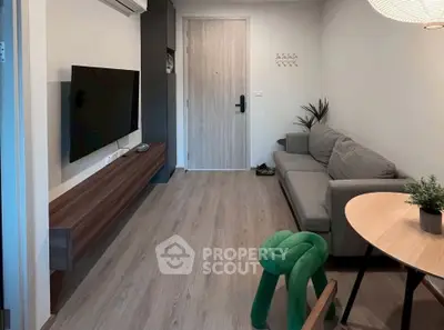 Modern living room with sleek furniture and wall-mounted TV, perfect for cozy relaxation.