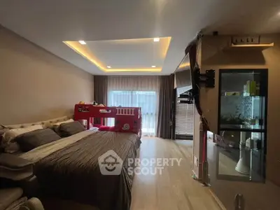 Spacious bedroom with modern lighting and bunk bed, ideal for family living.