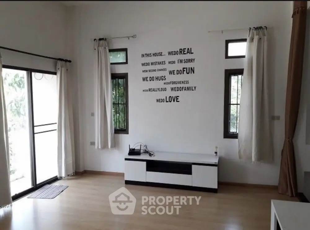 Spacious living room with large windows and modern decor