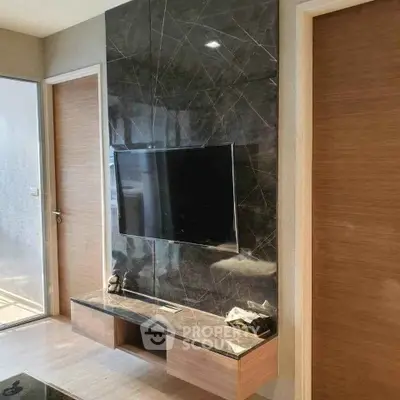 Modern living room with sleek TV setup and marble accent wall