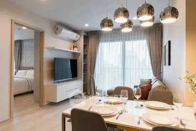 Modern open-plan living and dining area with elegant decor and city view.