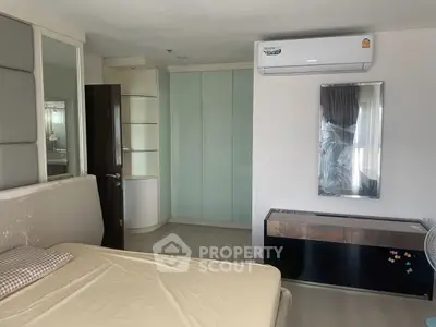 Modern bedroom with sleek design, air conditioning, and ample storage space.