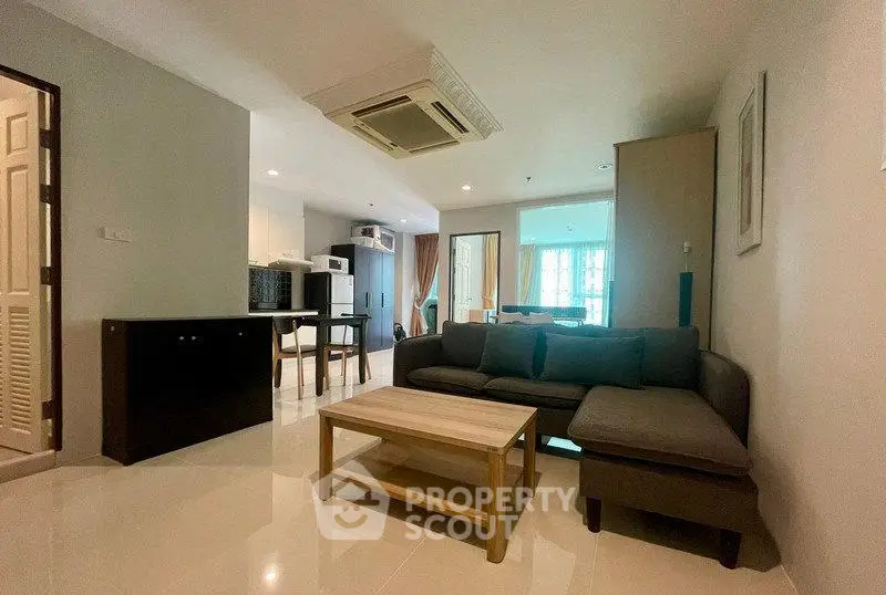 Spacious modern living room with sleek furniture and open layout in a stylish apartment.