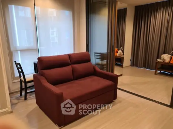 Modern living room with stylish furniture and floor-to-ceiling windows.