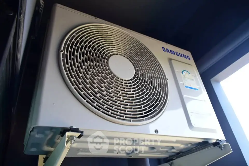 Modern air conditioning unit installed on exterior wall for efficient cooling.