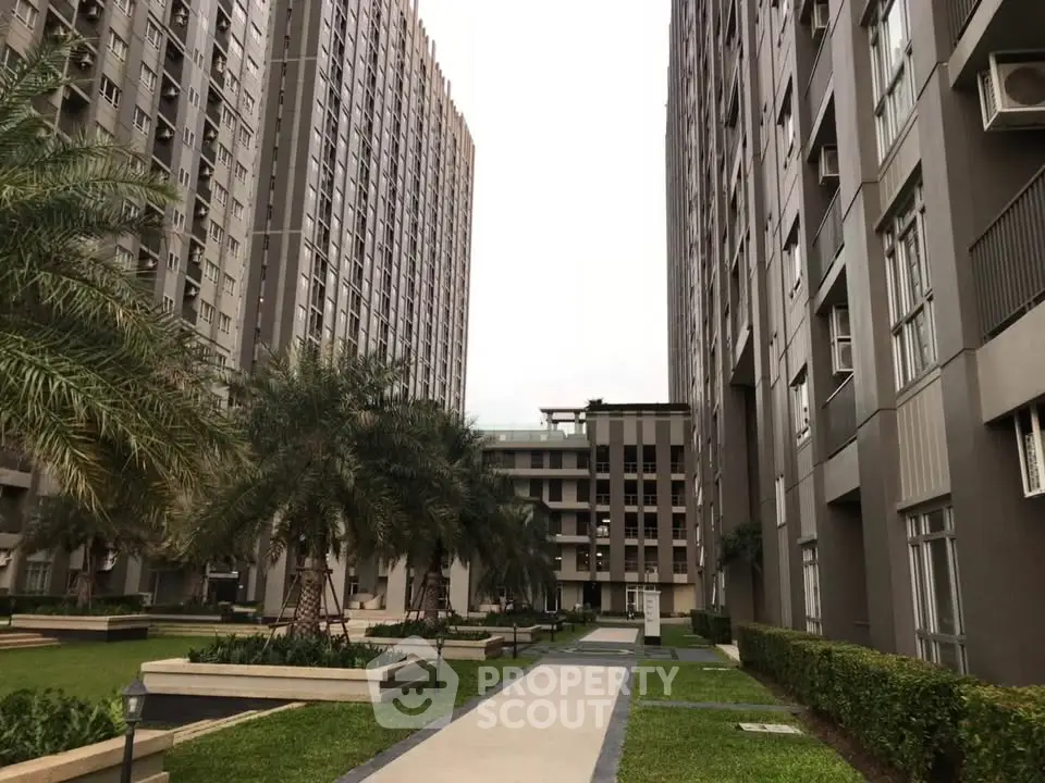 Modern residential complex with lush gardens and tall buildings