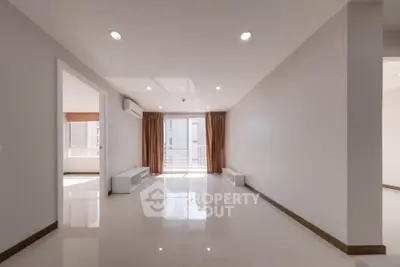 Spacious modern living room with large windows and natural light