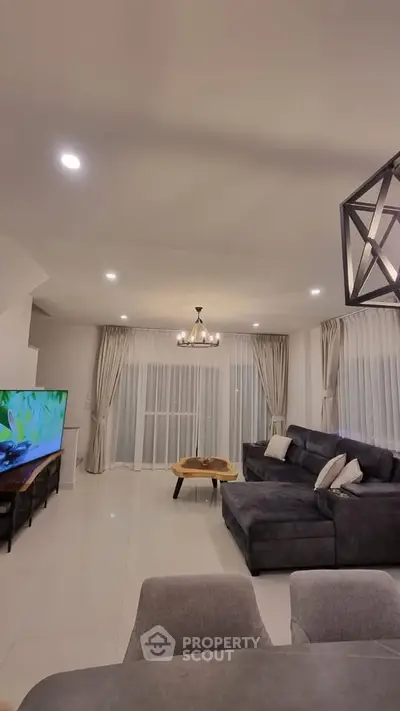 Spacious modern living room with elegant decor and large windows for natural light.