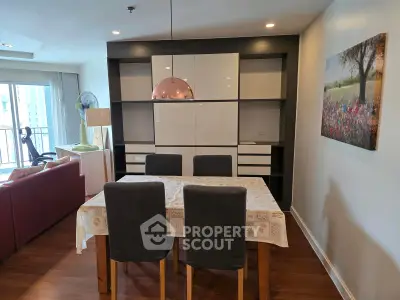 Modern dining area with stylish furniture and natural light in a contemporary apartment.
