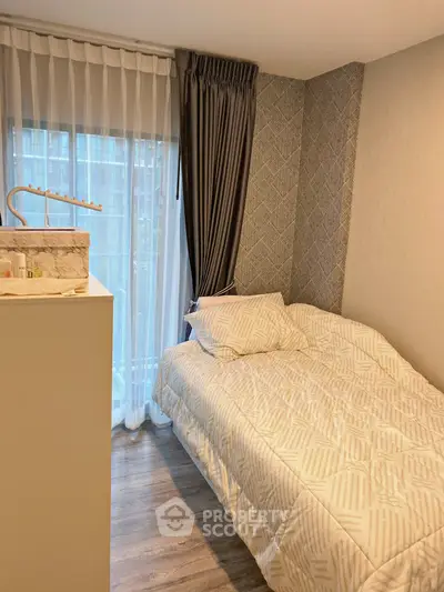 Cozy bedroom with modern decor and large window for natural light