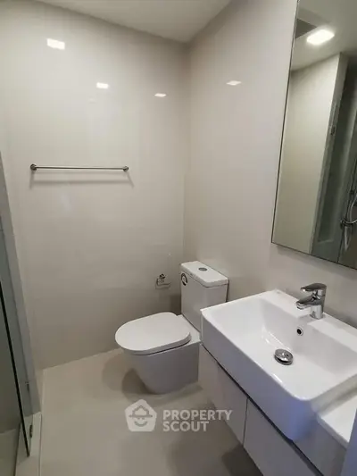 Modern minimalist bathroom with sleek fixtures and neutral tones