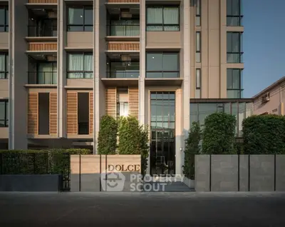 Elegant modern building facade with lush greenery and stylish entrance