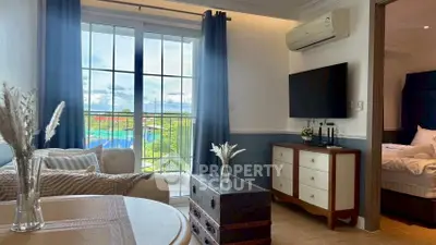 Charming living room with elegant decor and scenic balcony view, perfect for relaxation and comfort.