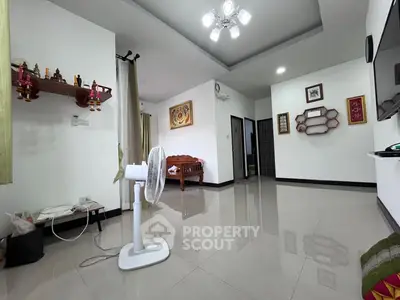 Spacious living room with modern decor and ceiling lighting