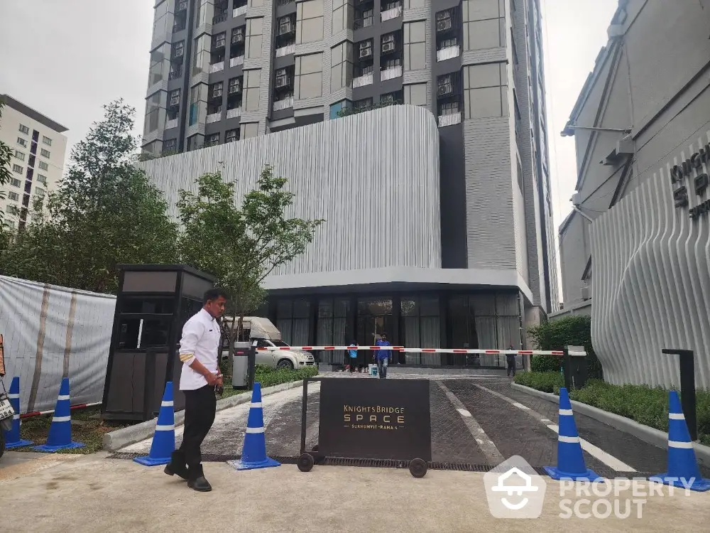 Modern high-rise building entrance with security and sleek design