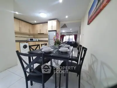 Spacious open-layout kitchen and dining area with modern appliances and elegant dining set.
