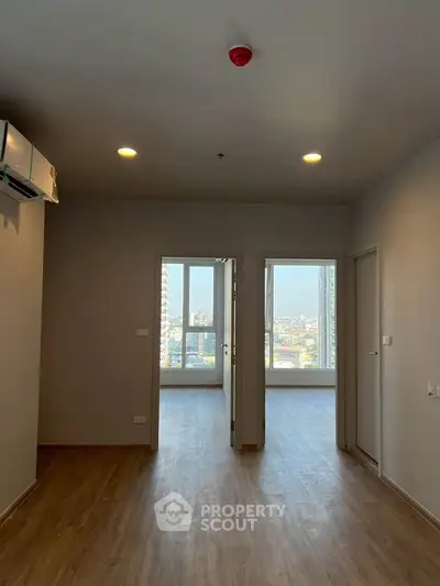 Spacious modern apartment with wooden flooring and city view