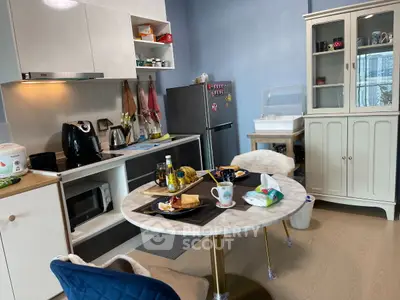Charming kitchen with modern appliances and cozy dining area, perfect for intimate meals.