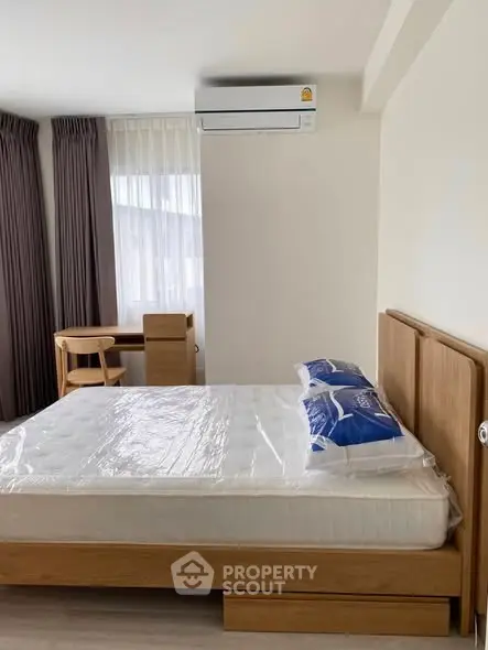 Modern bedroom with wooden furniture and air conditioning unit