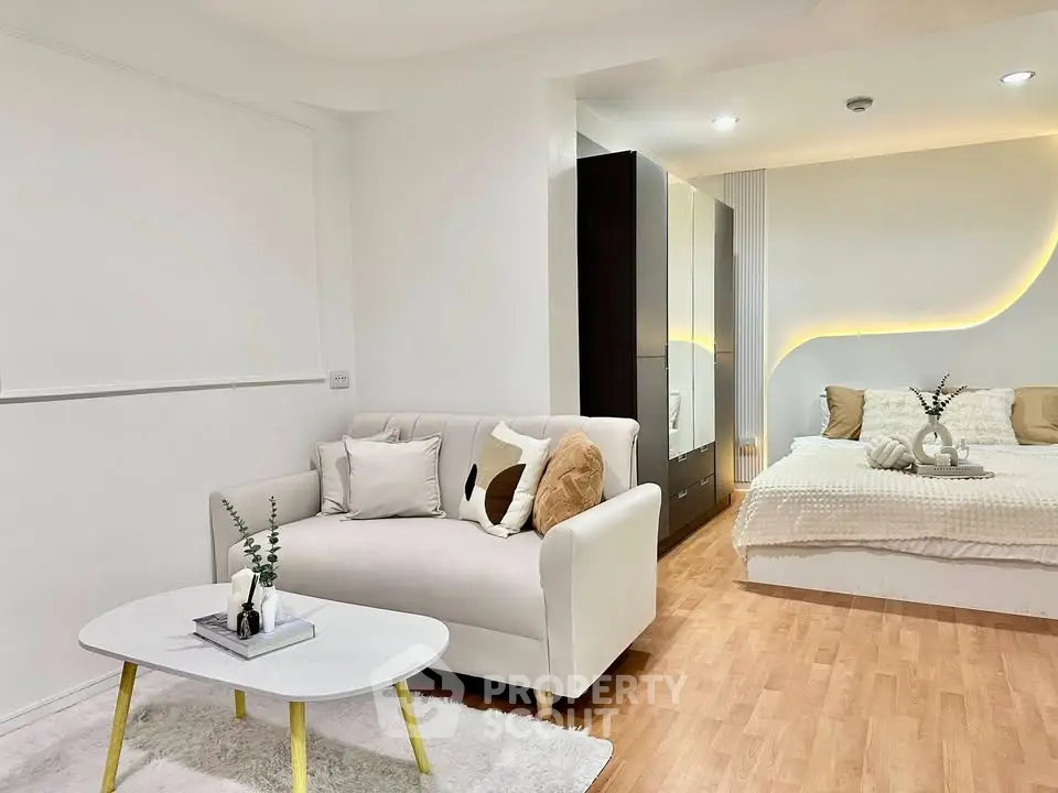 Modern studio apartment with cozy living area and stylish bedroom