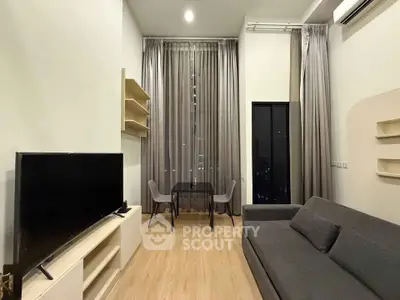 Modern living room with high ceilings, elegant curtains, and stylish furniture in a cozy apartment.