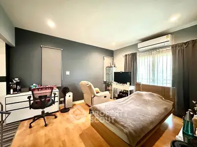 Spacious bedroom with modern decor and natural light, featuring a cozy bed and stylish furnishings.