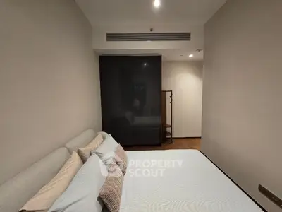 Modern bedroom with sleek design and cozy ambiance, featuring a stylish wardrobe and comfortable bedding.