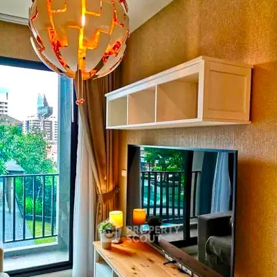 Modern living room with stylish lighting and balcony view in urban apartment.