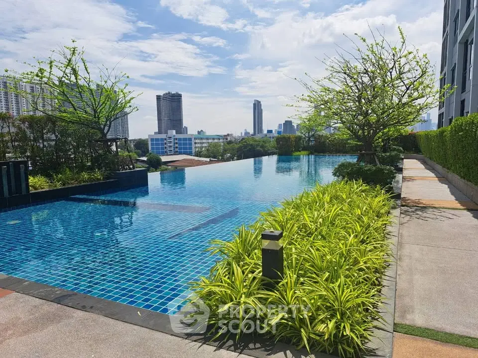 Luxurious rooftop pool with stunning city skyline views and lush greenery.