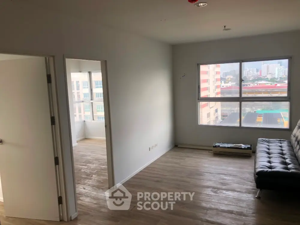 Spacious apartment living room with large windows and modern flooring
