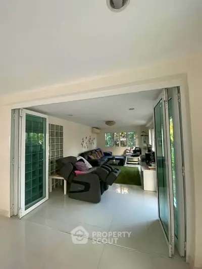 Spacious living room with modern decor and large windows for natural light