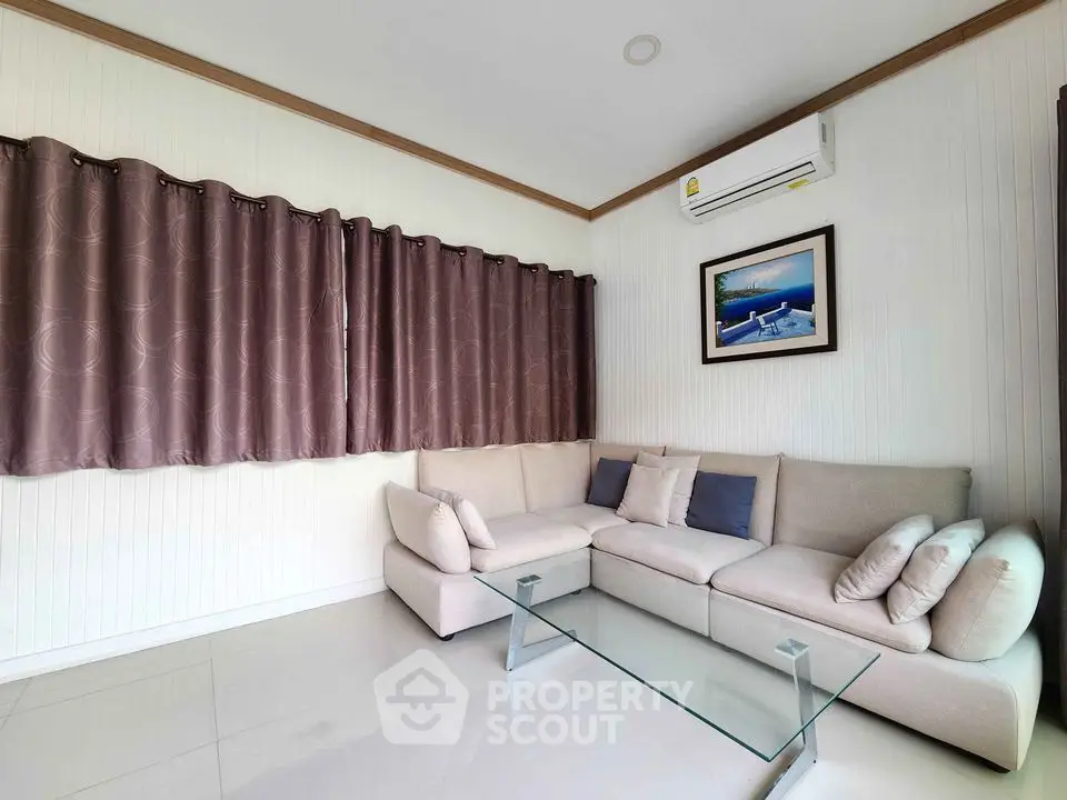 Modern living room with cozy sectional sofa and glass coffee table