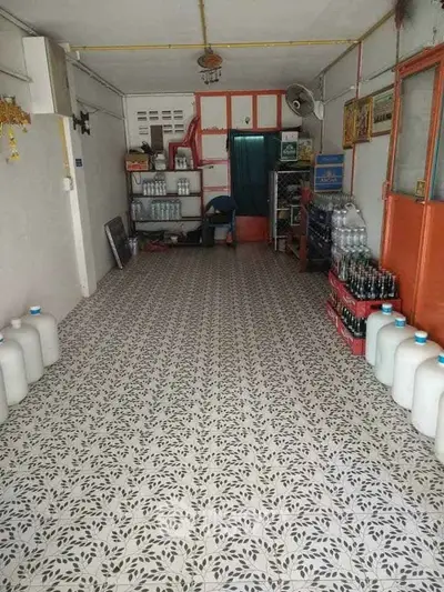 Spacious storage room with patterned tile flooring and ample shelving space.