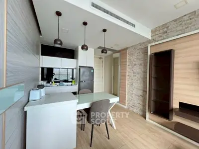 Modern kitchen with sleek design, featuring open layout and stylish dining area.