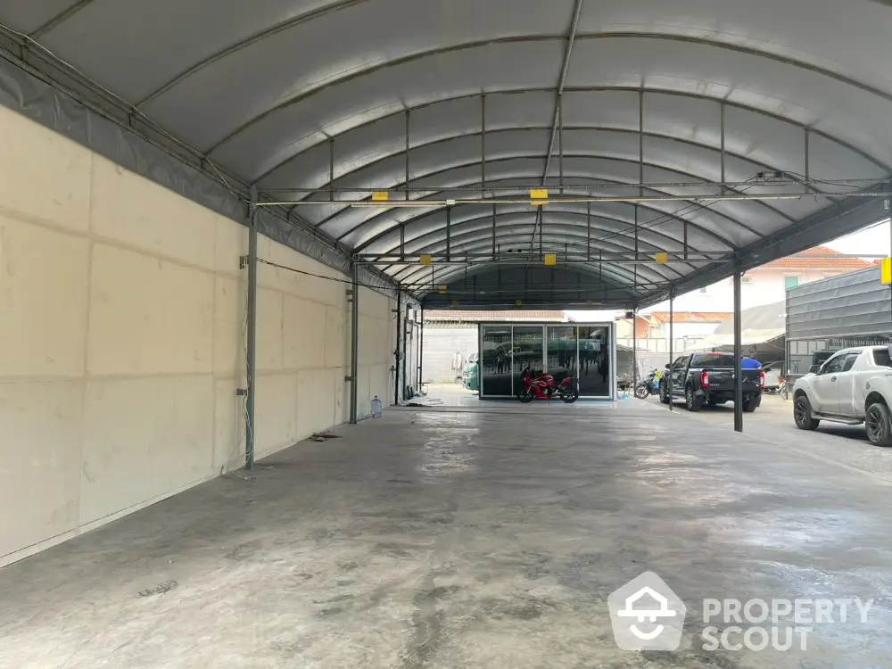 Spacious covered parking area with multiple vehicles and sturdy metal roof.