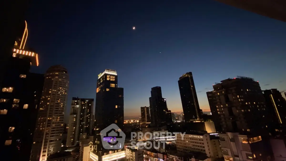 Stunning city skyline view at dusk with illuminated skyscrapers and a serene night sky.