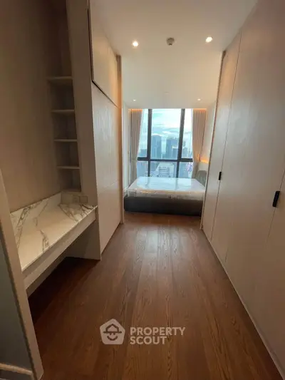 Luxurious bedroom with stunning city view and elegant wooden flooring