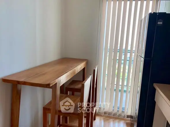 Cozy kitchen corner with wooden table and chairs near window blinds