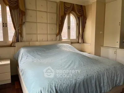 Luxurious bedroom with elegant drapery and plush headboard