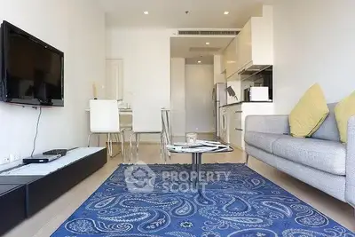Modern living room with open kitchen layout and stylish decor