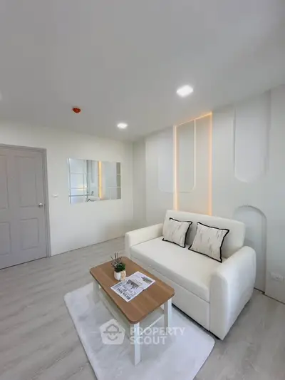 Modern living room with sleek white sofa and stylish decor