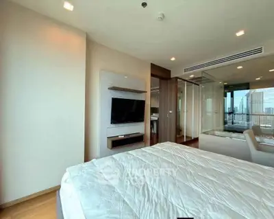 Modern bedroom with city view, featuring sleek design and integrated TV unit, perfect for urban living.