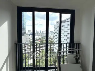 Stunning city view from a modern apartment balcony with sleek railing and ample natural light.