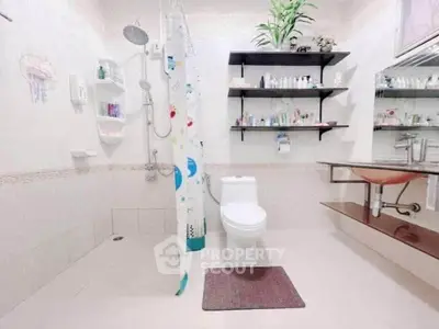 Modern bathroom with sleek fixtures and ample storage space, featuring a stylish shower and elegant sink.